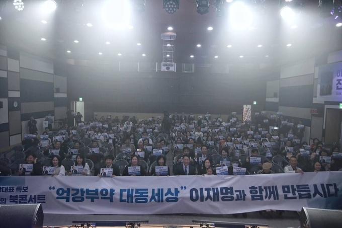 '억강부약 대동세상' 현수막을 들고 북콘서트에 참석한 참여자들이 퍼포먼스를 하고 있다.